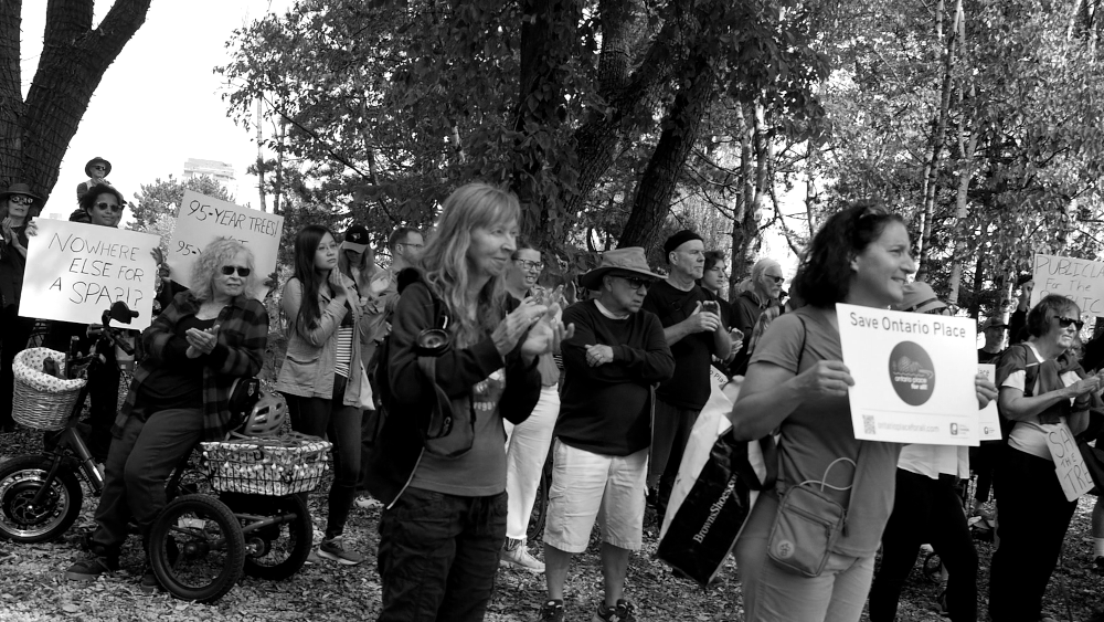 More crowd holding signs for Rally for the Trees at West Island, Ontario Place